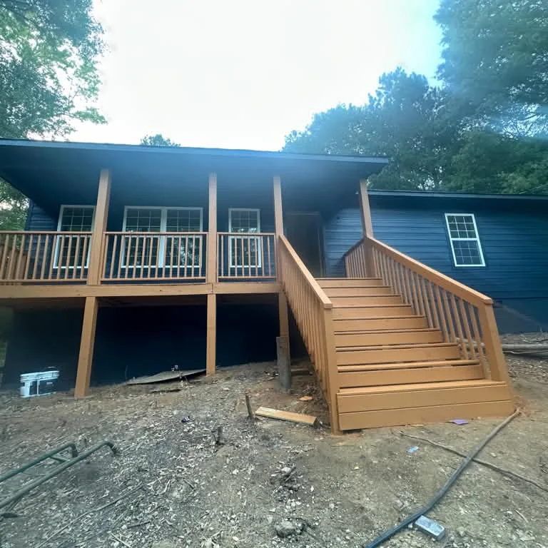 New wood deck and stairs built on the back of a house